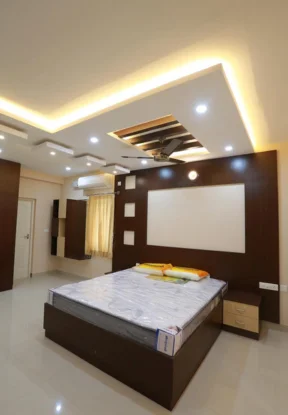 A cozy bedroom with a comfortable bed and a sleek television, perfect for transforming your bedroom.