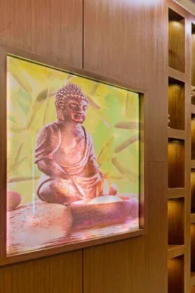 A serene Buddha statue set in an environment of calm makes the living room feel optimistic.