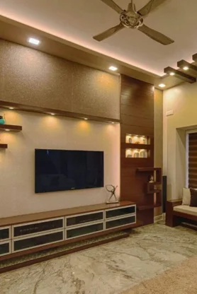 A contemporary living area with lighting and a ceiling fan creates a pleasant atmosphere.