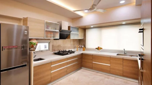 Contemporary kitchen with fridge, oven, and microwave against walls and stainless steel appliances.