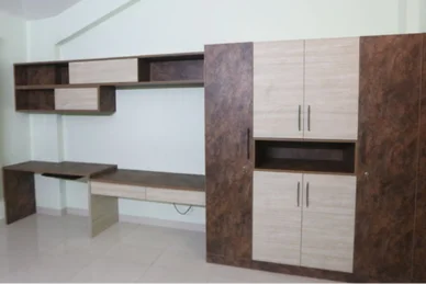 An efficiently structured room incorporating an accent wall unit of service, office, and cupboard.