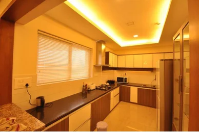 A contemporary cooking area features a microwave use, and refrigerator as well along with dishwasher