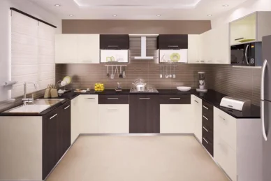 An modular kitchen design, with white and black cabinets and appliances, boasts a sleek appearance.