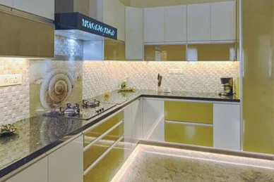 In a modular kitchen layout, a kitchen is equipped with white and black cabinets and appliances.