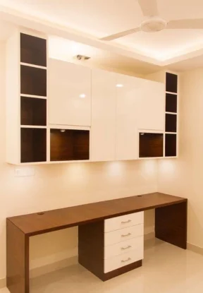 A view of a room with a cabinet & desk made of brown & white materials for office interior design