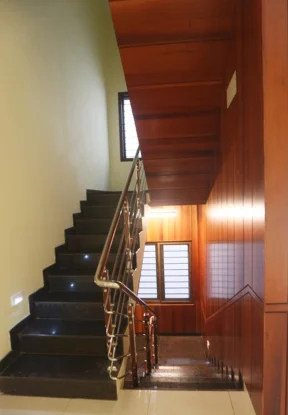 A stairway with railing, located within a portfolio of step-side interior, is part of the project. 