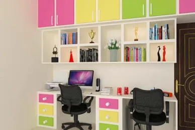 An energetic atmosphere fills the room with a desk and computer, adorned with colorful decorations.