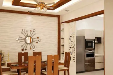 A modern dining area features a modern ceiling fan above the dining table and a design wall texture.