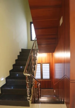 The stylish stairway with its sleek railing and exquisite interior design showcases itself.