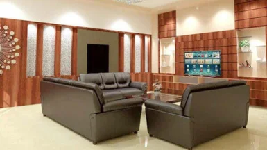 A modern living room with elegant leather furniture, wall décor, and a huge flat-screen TV.