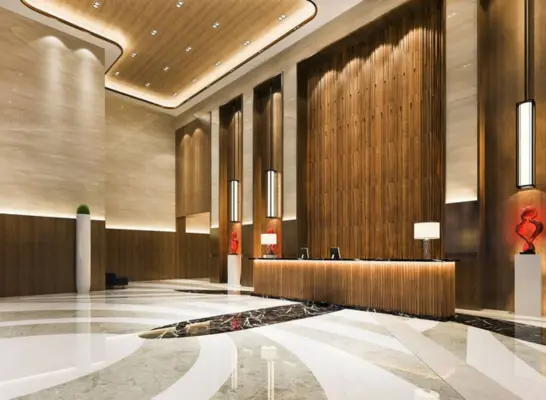 A modern house lobby with wood panelling and marble floors that scream refinement and elegance.
