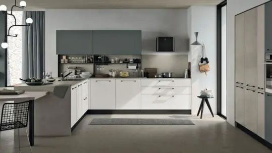 A modern L-shaped kitchen with sleek grey and white cabinets that give off a chic appearance.